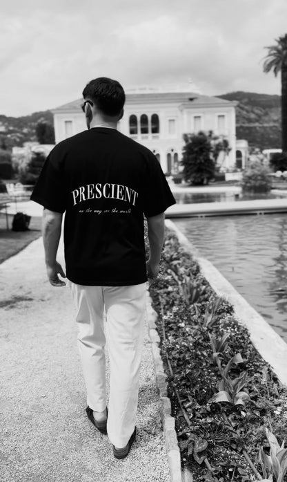 Model wearing Prescient Classic Black T-Shirt walking at Villa & Jardins Ephrusi Rothschild in Monaco